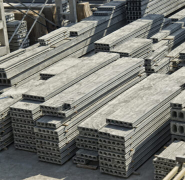 Stack of precast reinforced concrete slabs in a house-building factory workshop