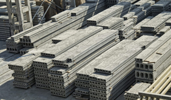 Stack of precast reinforced concrete slabs in a house-building factory workshop